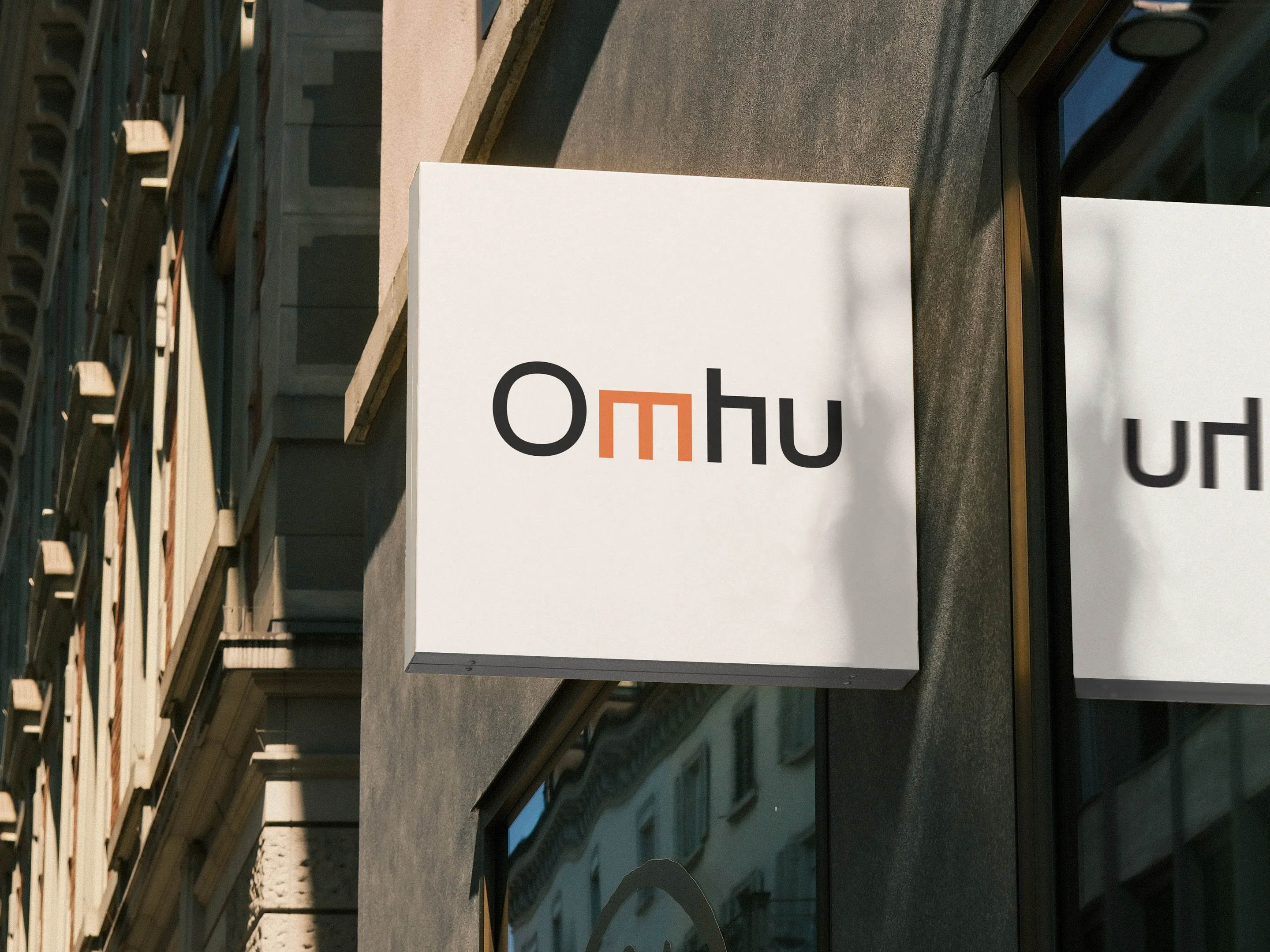 An Omhu sign on a building facade